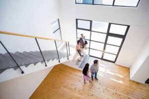 A tidy home entrance with a freshly swept porch, trimmed shrubs, and a clean doormat under a covered entryway.